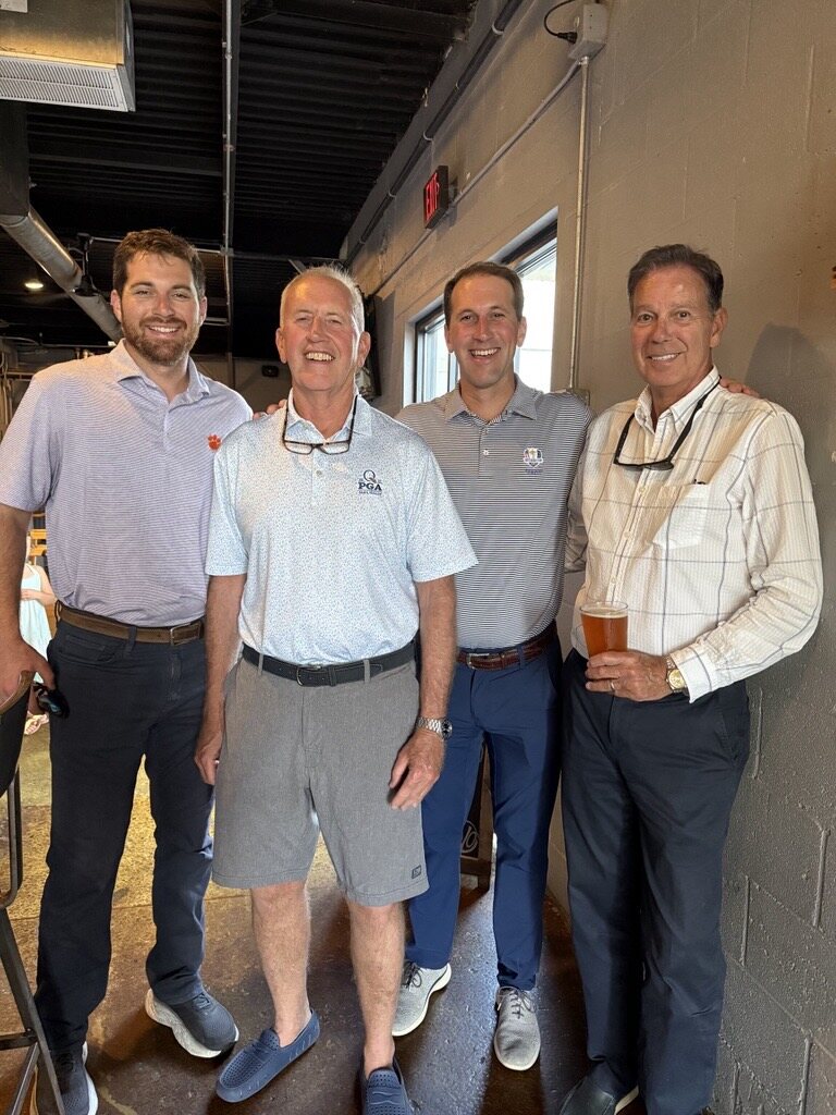 Ross Evans with three attendees at the Evolution Brewing fundraiser.