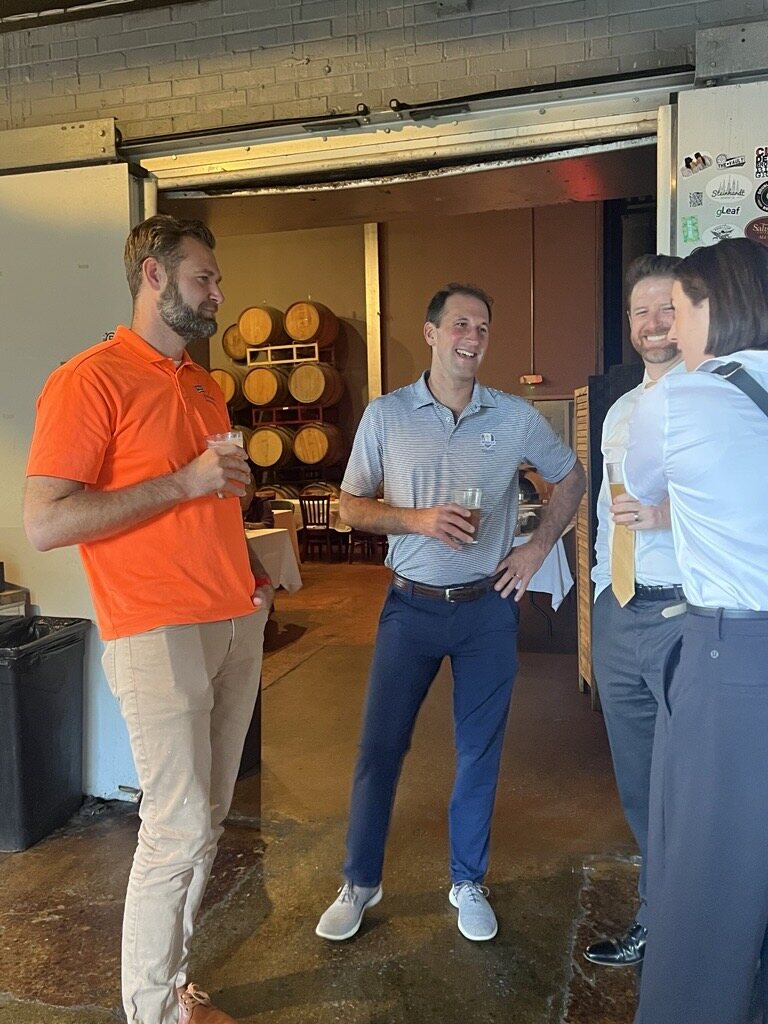 Ross Evans talking with attendees inside Evolution Brewing.