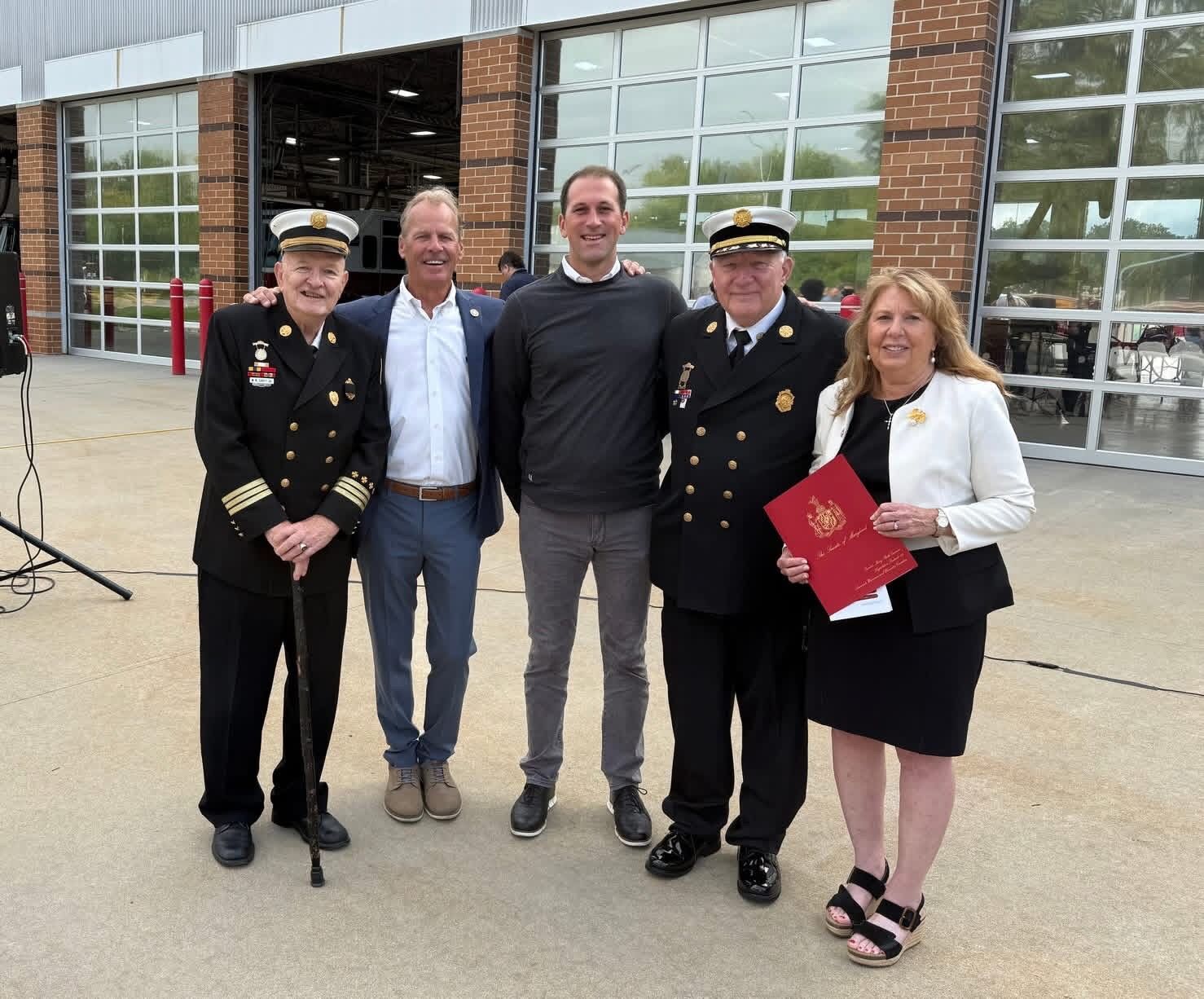 Ross Evans with fire department leadership and community members outside Station 16