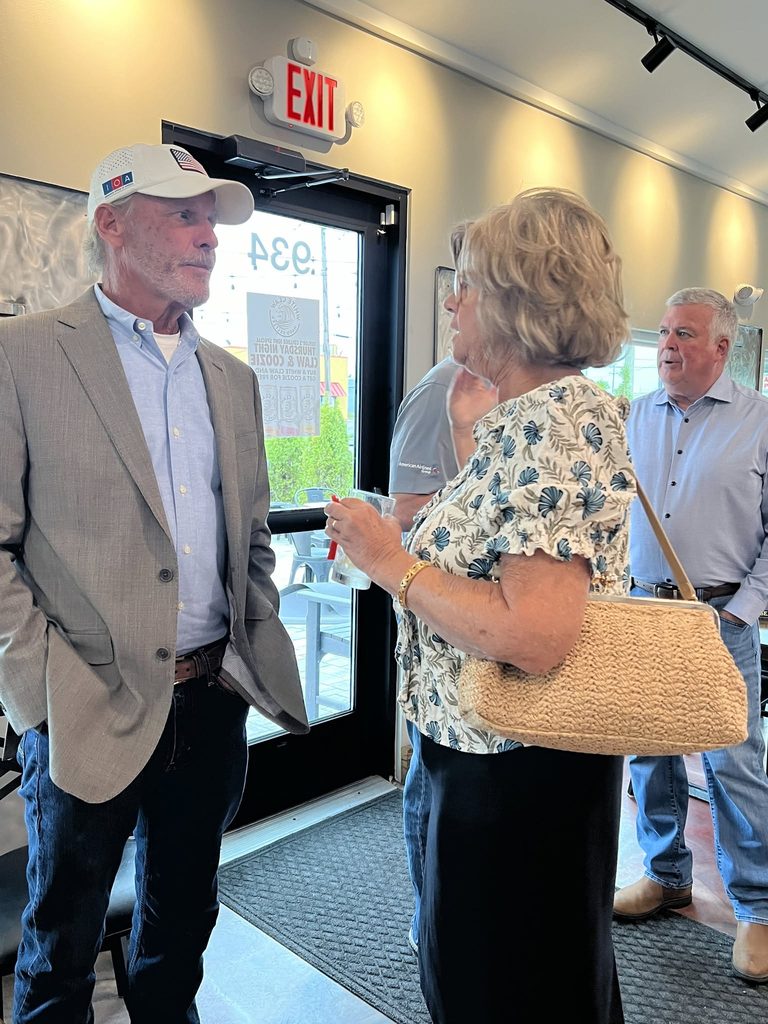 Guests talking near the entrance at Taylor's BBQ.