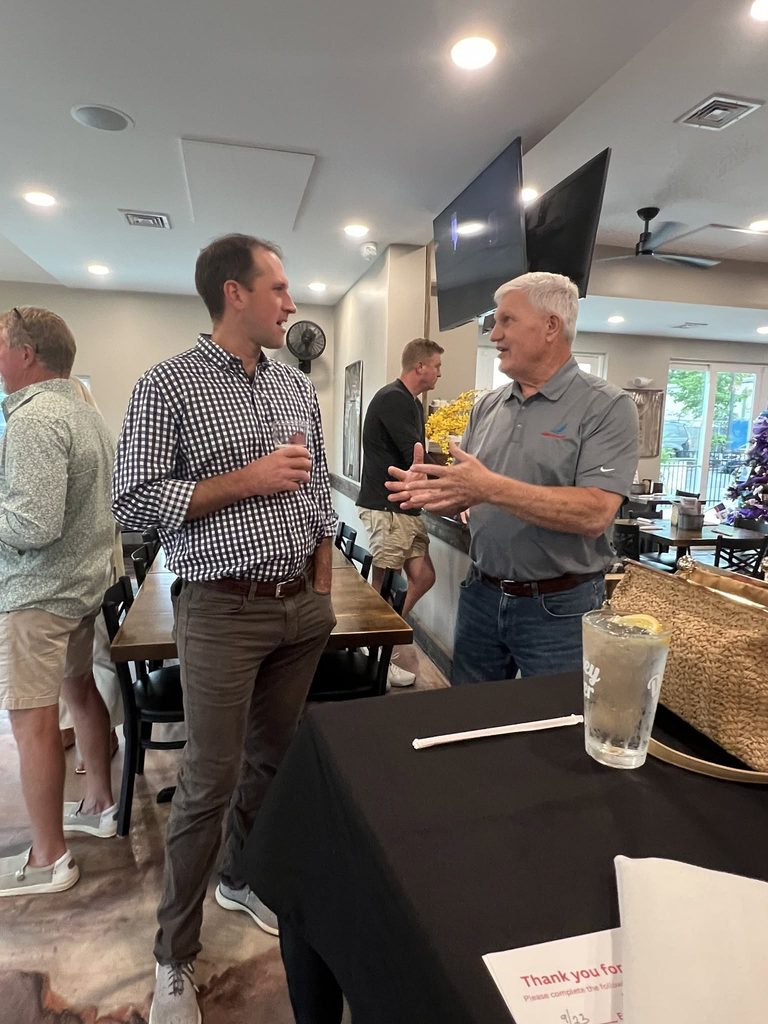 Ross Evans in conversation with a guest at Taylor's BBQ.